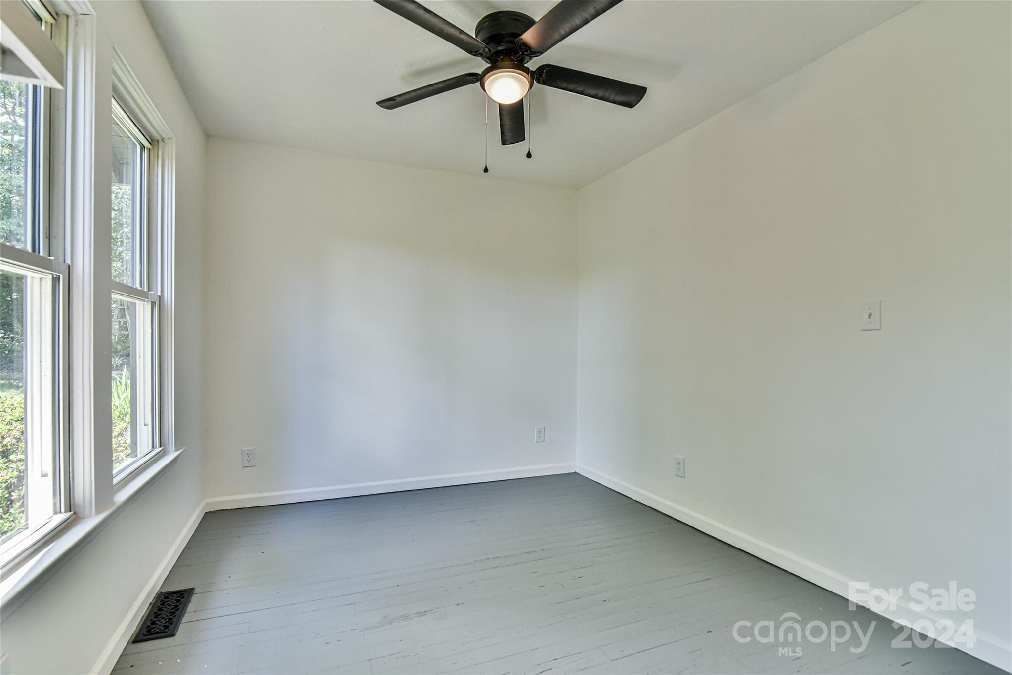 210 East Oakview Road Asheville, NC 28806 - Photo 15 of 31 an empty room with a window and a fan
