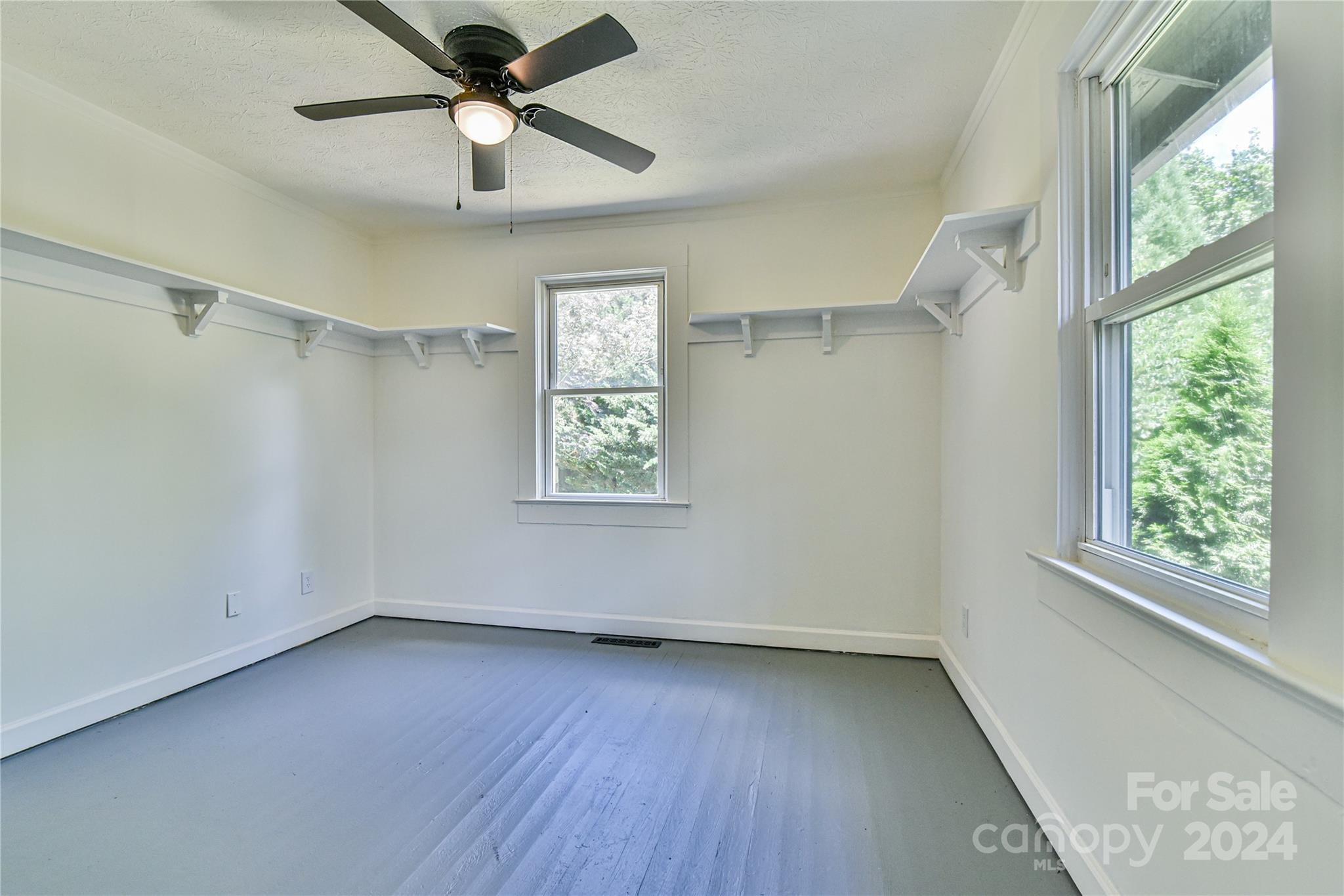 210 East Oakview Road Asheville, NC 28806 - Photo 21 of 31 a view of an empty room with a window and wooden floor