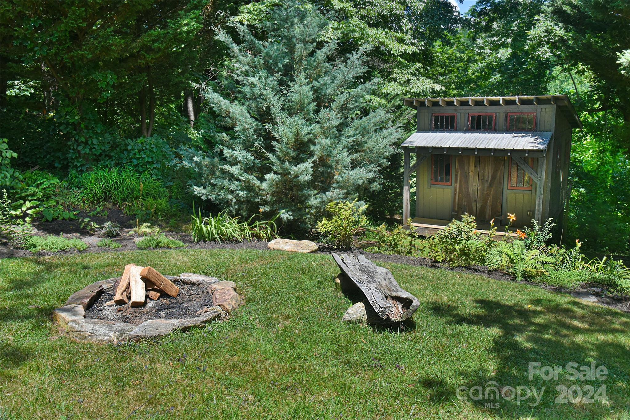 210 East Oakview Road Asheville, NC 28806 - Photo 28 of 31 a view of a small house with a yard and sitting area