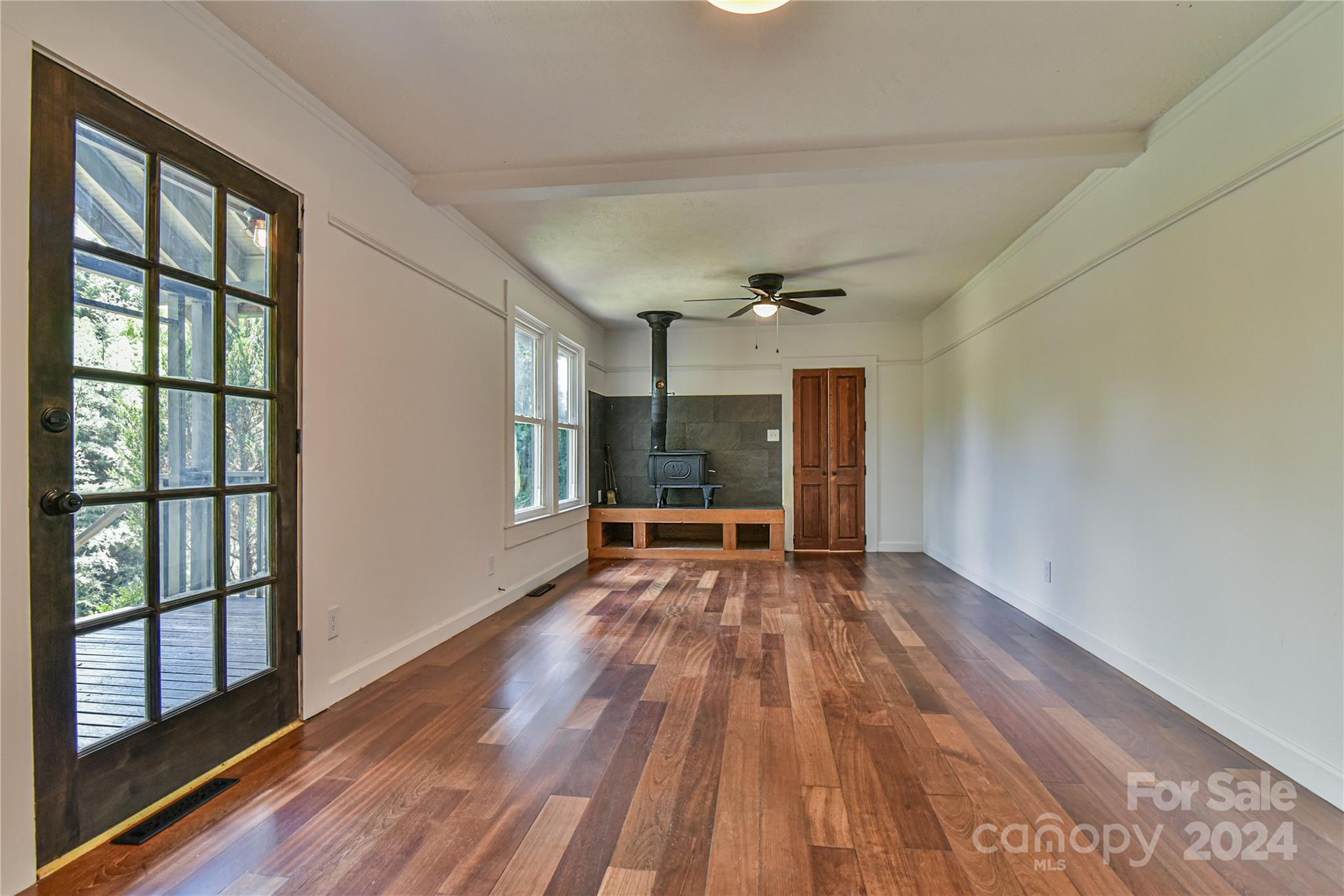 210 East Oakview Road Asheville, NC 28806 - Photo 5 of 31 a view of an empty room with wooden floor and a window