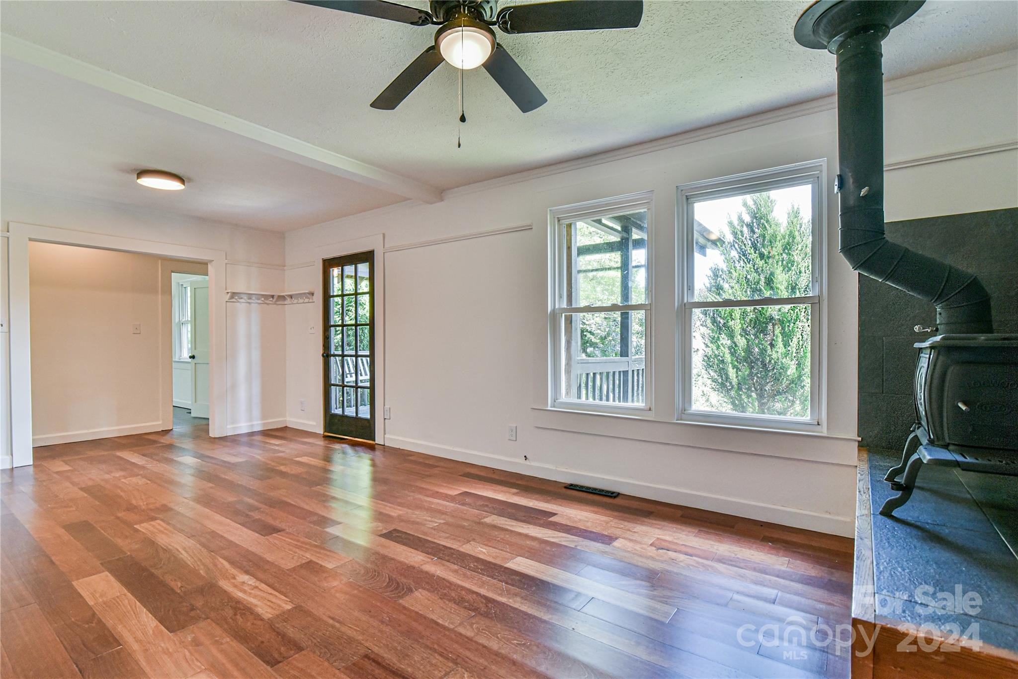 210 East Oakview Road Asheville, NC 28806 - Photo 7 of 31 a view of an empty room with a window and wooden floor