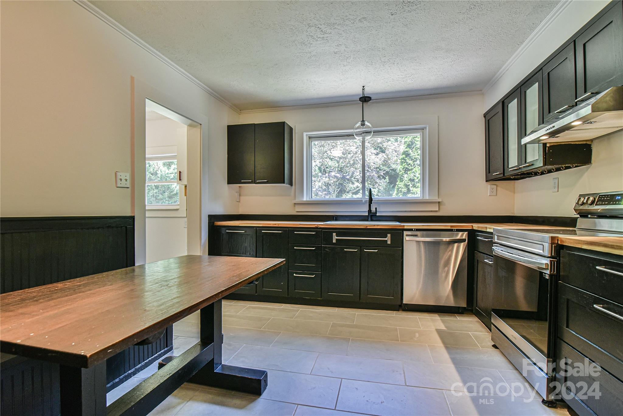 210 East Oakview Road Asheville, NC 28806 - Photo 8 of 31 a kitchen with stainless steel appliances granite countertop a sink and a stove