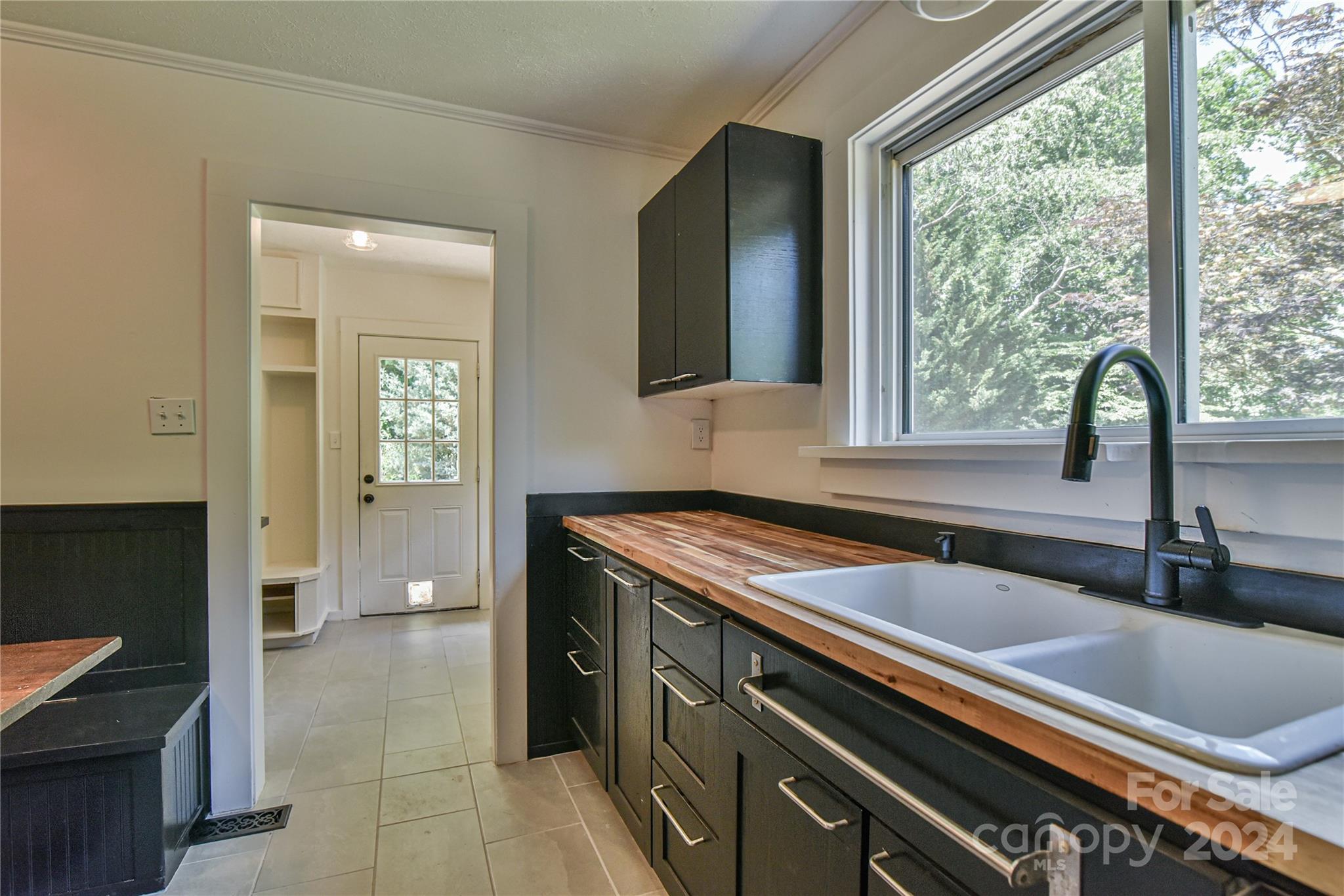 210 East Oakview Road Asheville, NC 28806 - Photo 10 of 31 a kitchen that has a sink a stove and a window