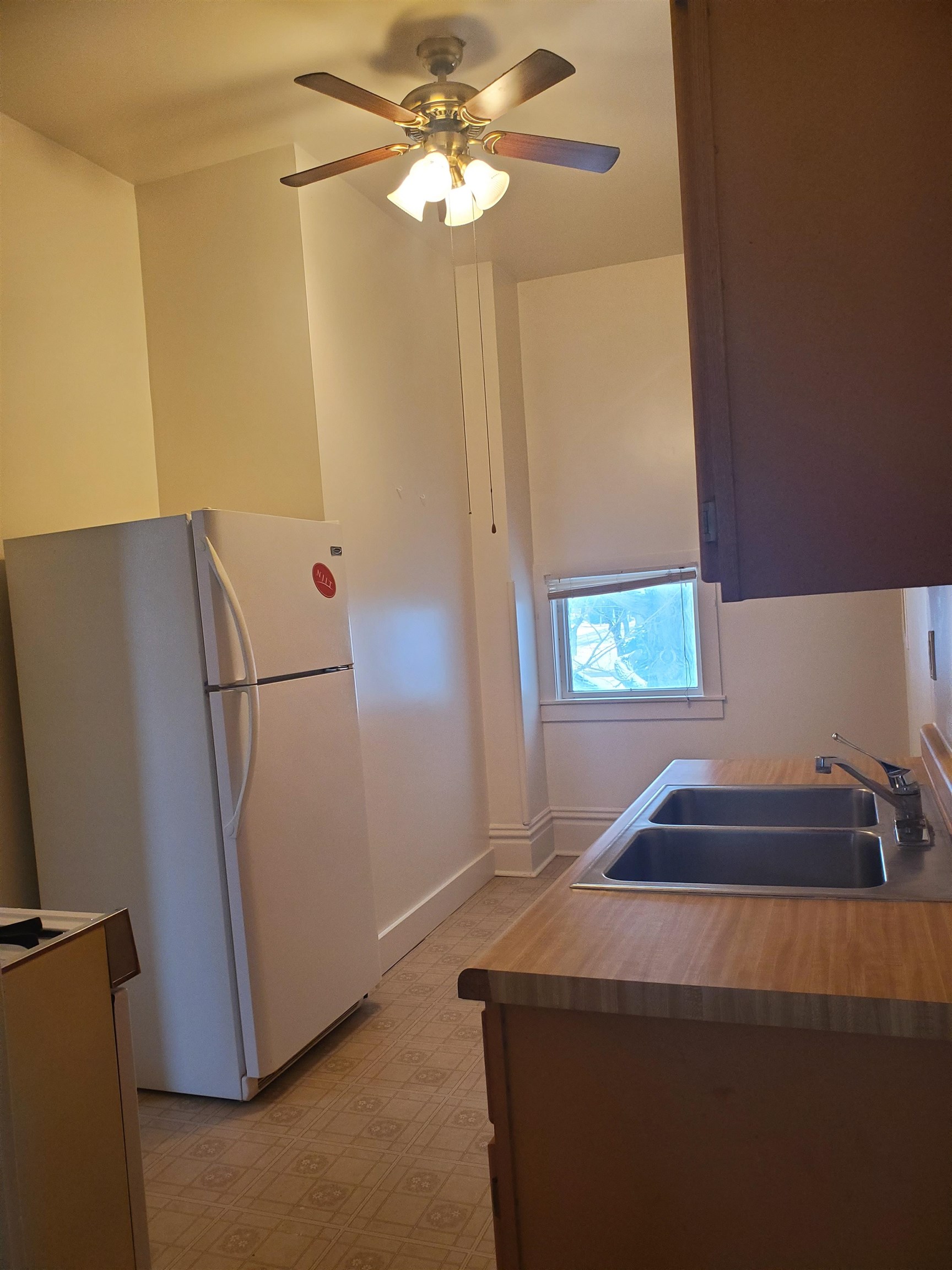 400 North 4th Street Oregon, IL 61061 - Photo 18 of 24 a room with a refrigerator and a chandelier