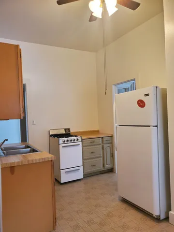 a kitchen with cabinets and refrigerator