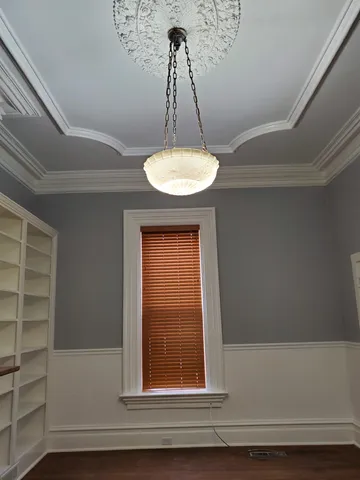 a bathroom with a window and a chandelier