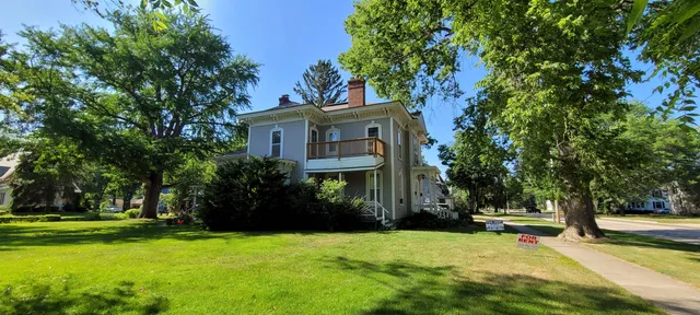 a view of a house with a tree in front of a house