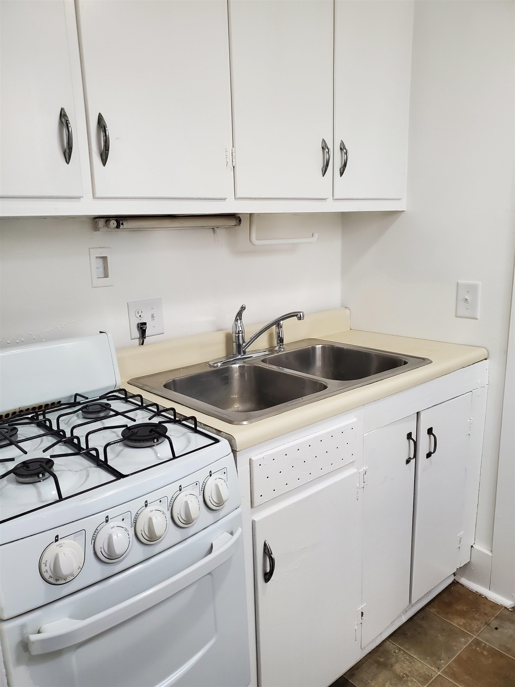 400 North 4th Street Oregon, IL 61061 - Photo 9 of 24 a kitchen with white cabinets and white appliances