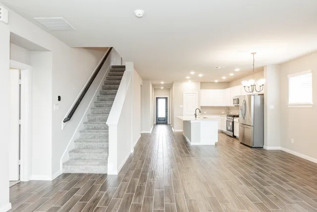 a view of a kitchen with wooden floor and a sink