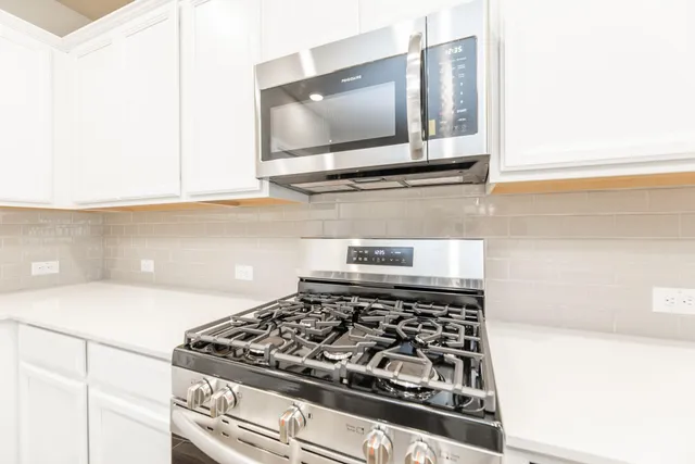 a kitchen with a stove and a microwave