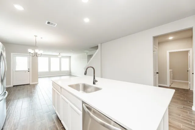 a large white kitchen with a sink