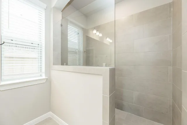 a bathroom with a shower and a sink