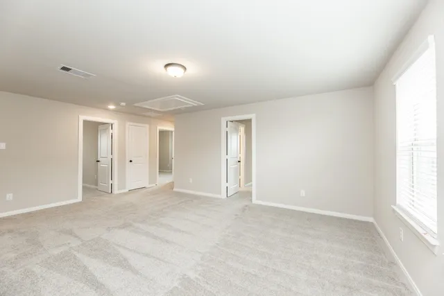 a view of an empty room and a window