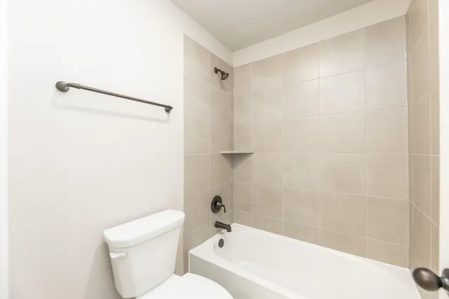 a bathroom with a toilet and a bathtub