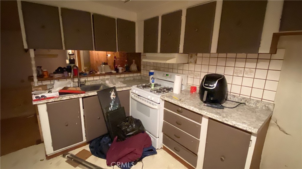 17698 Walker Mine Road Redding, CA 96003 - Photo 10 of 29 a kitchen with a sink stove and cabinets