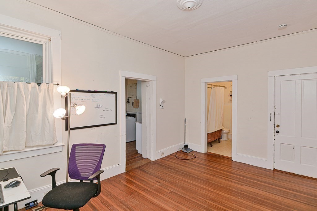 183 Main Street Northampton, MA 01053 - Photo 22 of 42 a bedroom with a bed and wooden floor