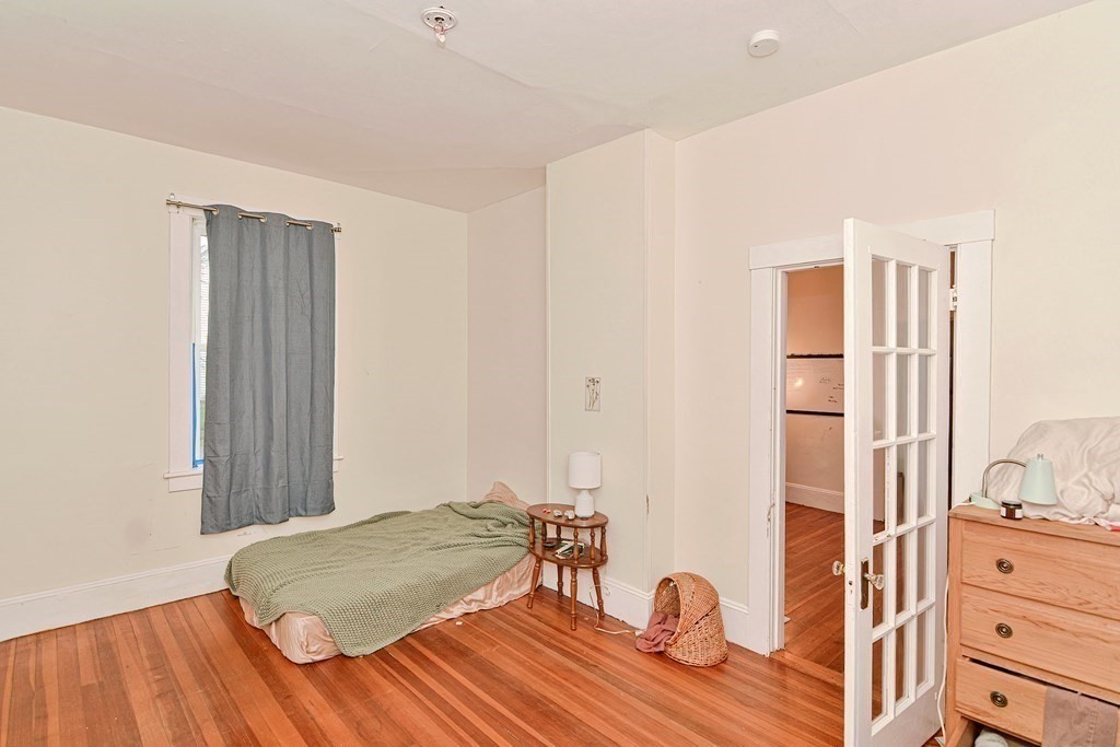 183 Main Street Northampton, MA 01053 - Photo 27 of 42 a bedroom with a bed and a table