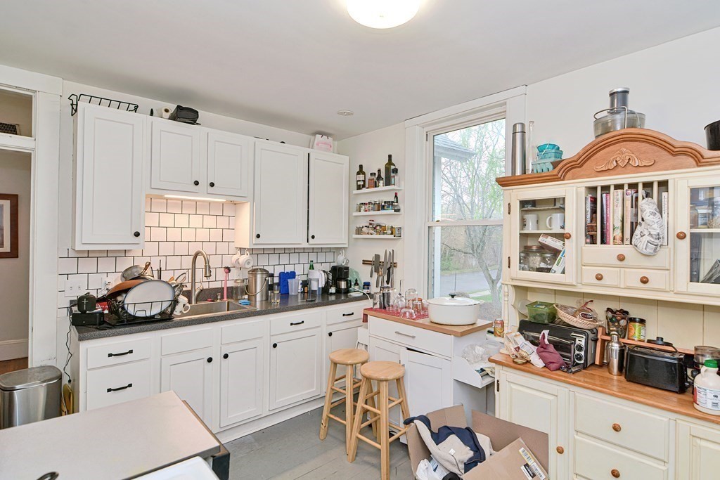 183 Main Street Northampton, MA 01053 - Photo 31 of 42 a kitchen with a sink stove and cabinets