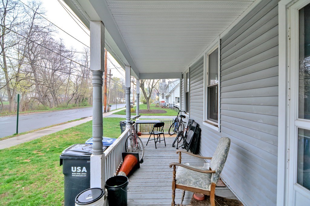 183 Main Street Northampton, MA 01053 - Photo 6 of 42 a view of a porch with chairs and a yard