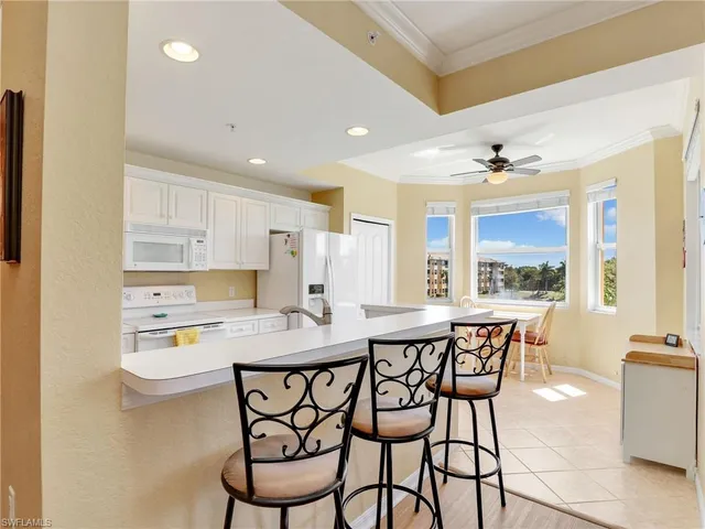 a kitchen that has a table and chairs in it