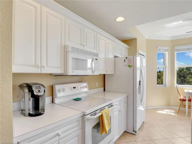 a kitchen with a refrigerator and a stove top oven