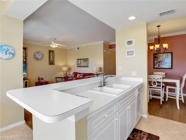 a kitchen with a sink a counter space and dining table