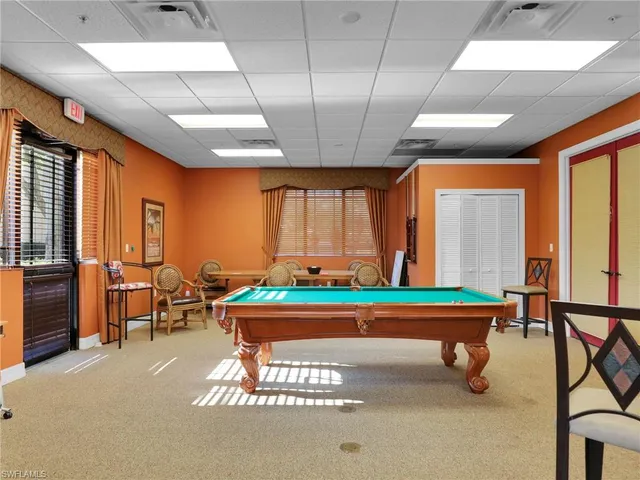 a view of a dining room with furniture and a chandelier