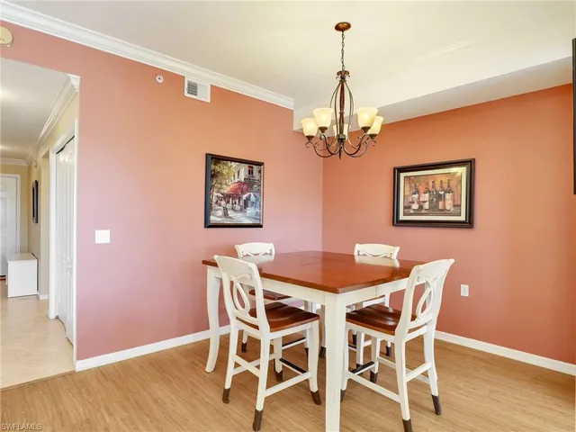 a view of a dining room with furniture wooden floor and chandelier