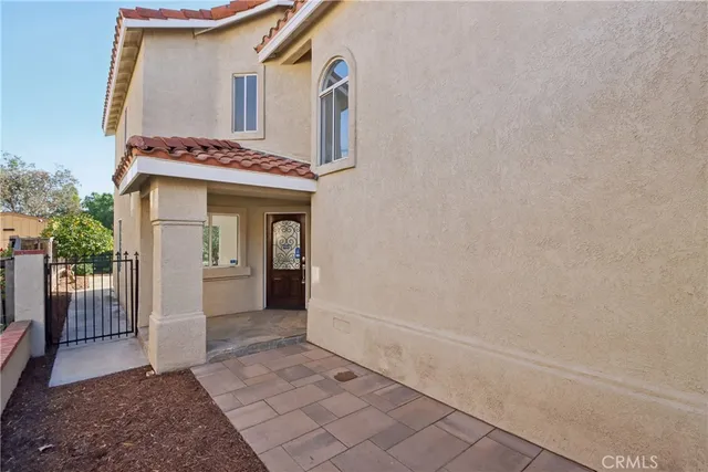 a view of a house with a wooden fence