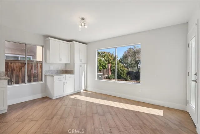 a view of a kitchen with a dishwasher cabinets and a large window