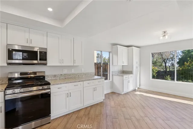 a kitchen with a sink stove and microwave