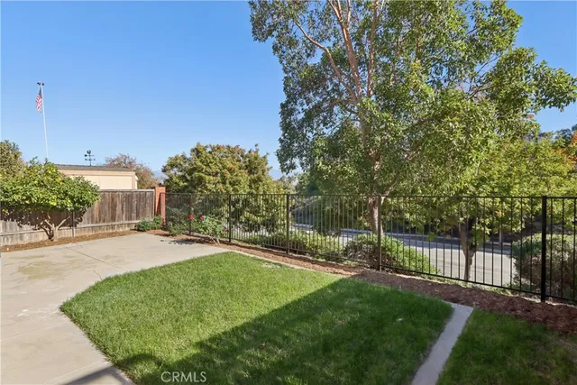 a front view of a house with a garden and plants