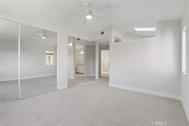 an empty room with a bathroom and a shower