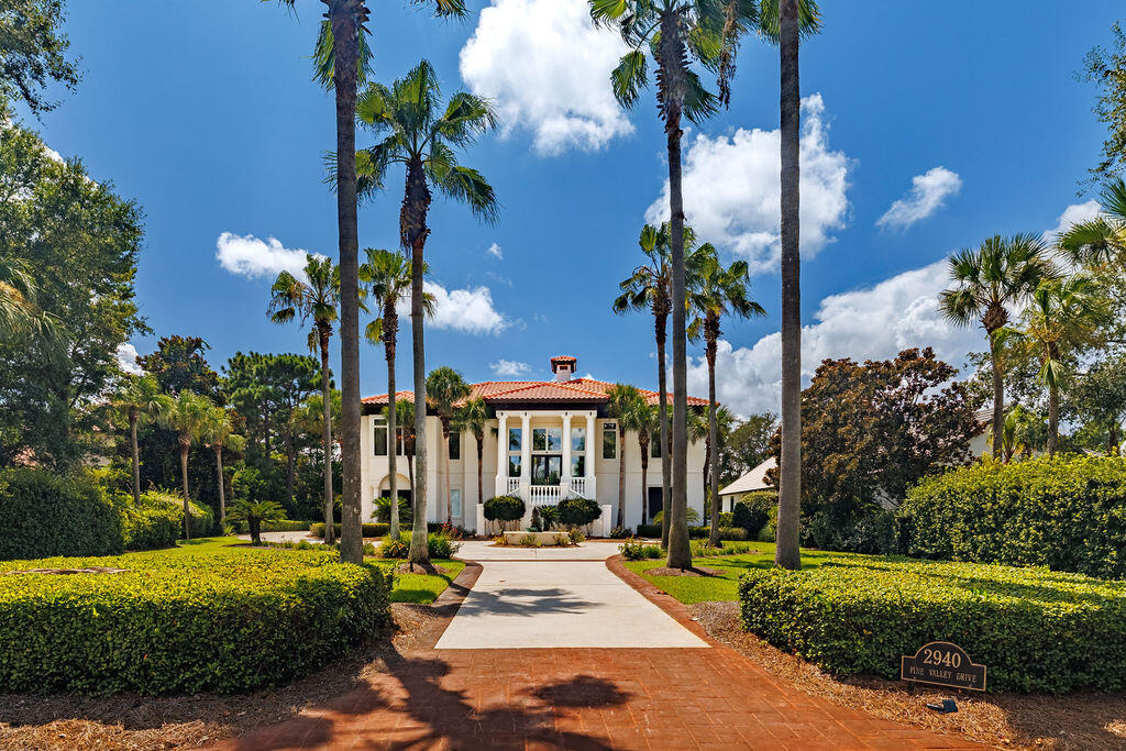 2940 Pine Valley Road Miramar Beach, FL 32550 - Photo 14 of 97 a view of a patio with table and chairs potted plants and large tree