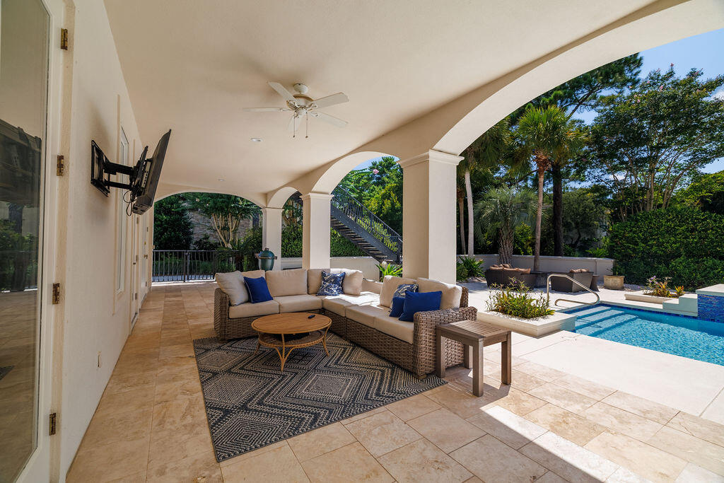 2940 Pine Valley Road Miramar Beach, FL 32550 - Photo 28 of 97 a outdoor space with patio the couches and a dining table with garden view