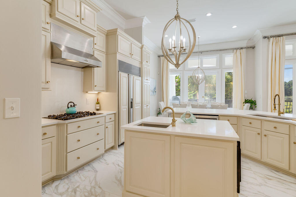 2940 Pine Valley Road Miramar Beach, FL 32550 - Photo 46 of 97 a kitchen with cabinets stainless steel appliances a sink and a chandelier