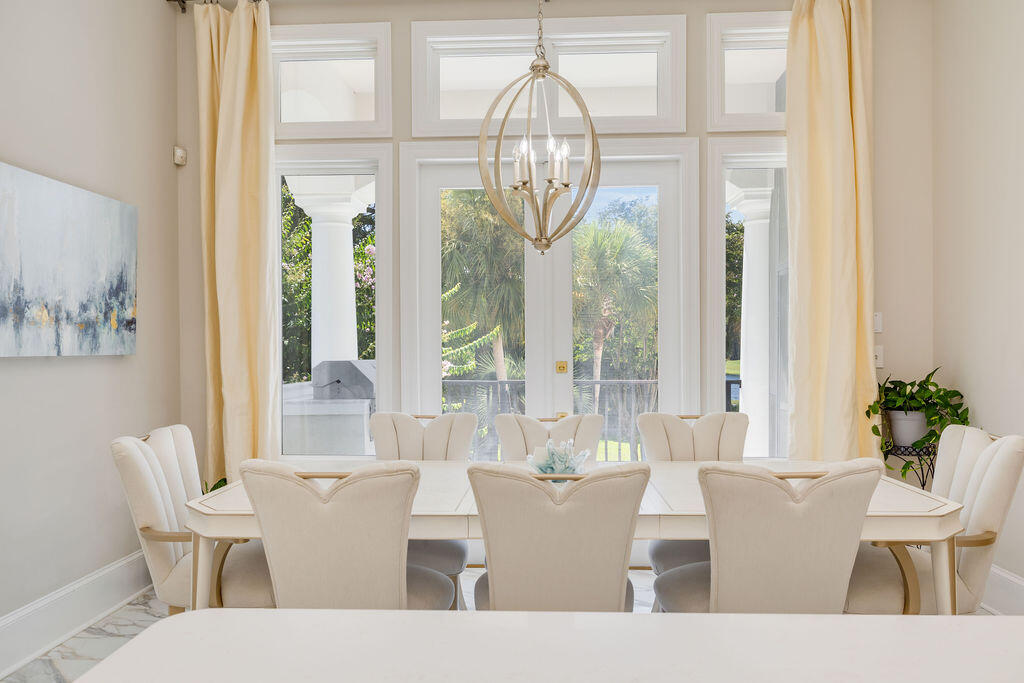 2940 Pine Valley Road Miramar Beach, FL 32550 - Photo 47 of 97 a living room with couches a table and a chandelier