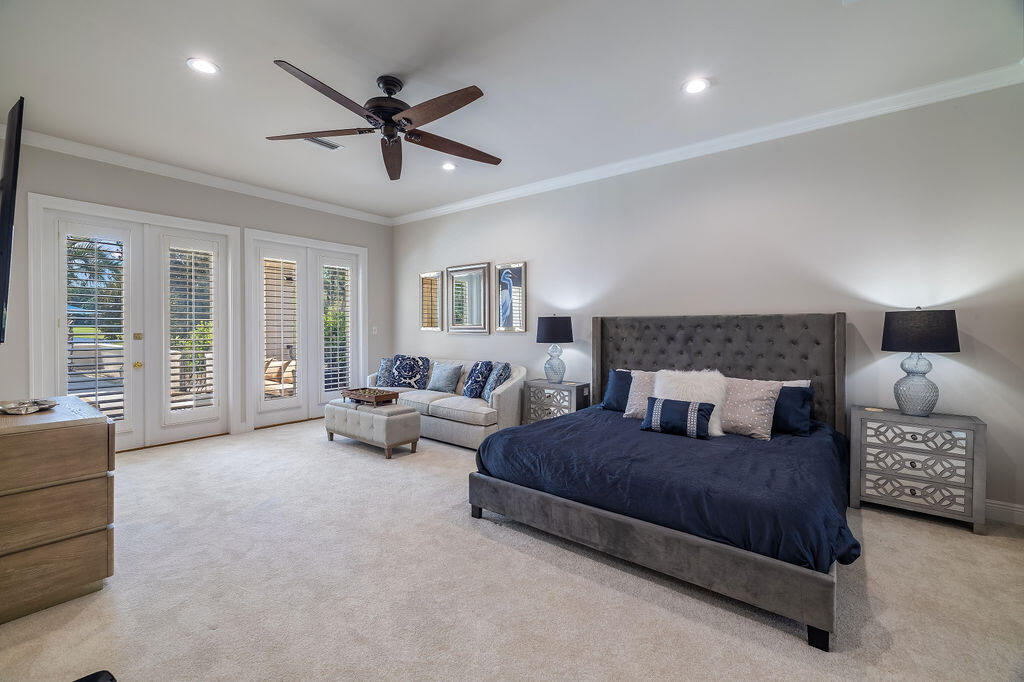 2940 Pine Valley Road Miramar Beach, FL 32550 - Photo 70 of 97 a spacious bedroom with a bed a couch and a chandelier