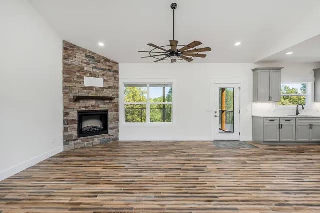 a view of a kitchen an empty room and window a fireplace