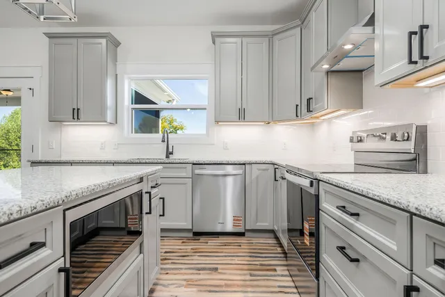 a kitchen with granite countertop a sink and cabinets