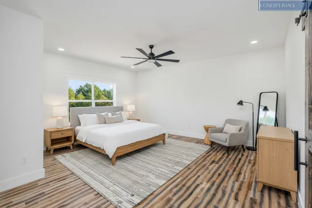 a living room with a bed furniture and a window