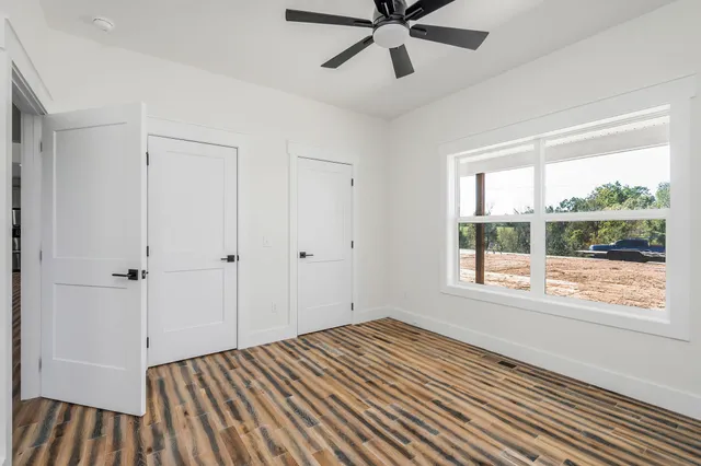a bathroom with a granite countertop sink a toilet and a mirror