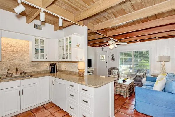 a dining room with furniture a chandelier and window