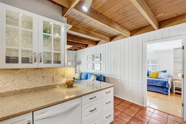 a view of a dining room with furniture a chandelier and wooden floor