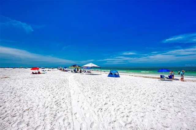 a view of a patio with table and chairs with a barbeque grill and plants