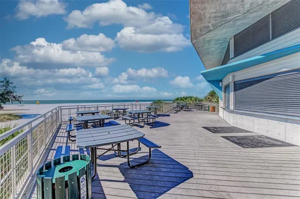 a view of a patio with a table and chairs under an umbrella