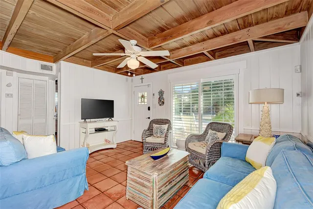 a living room with furniture a rug and a window