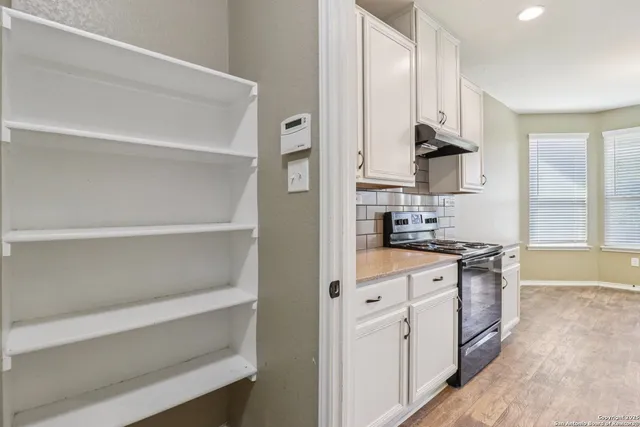 a view of storage and utility room with closet