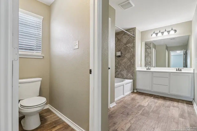 a bathroom with a bathtub and a sink