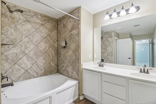 a bathroom with a bathtub and a shower